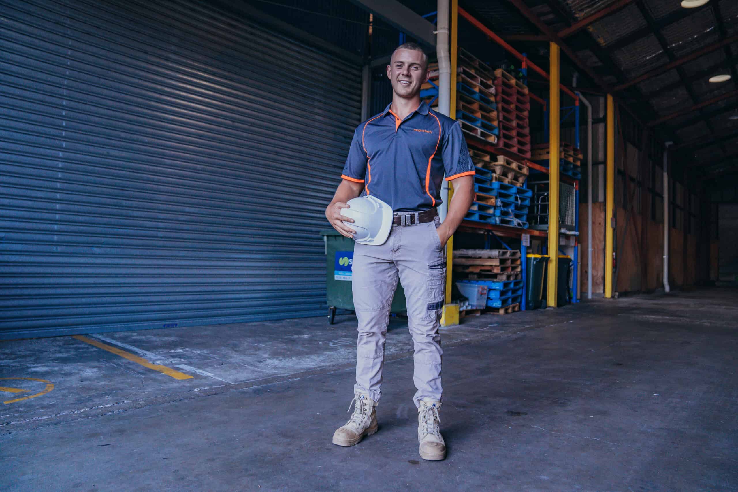 A man standing holding a hat